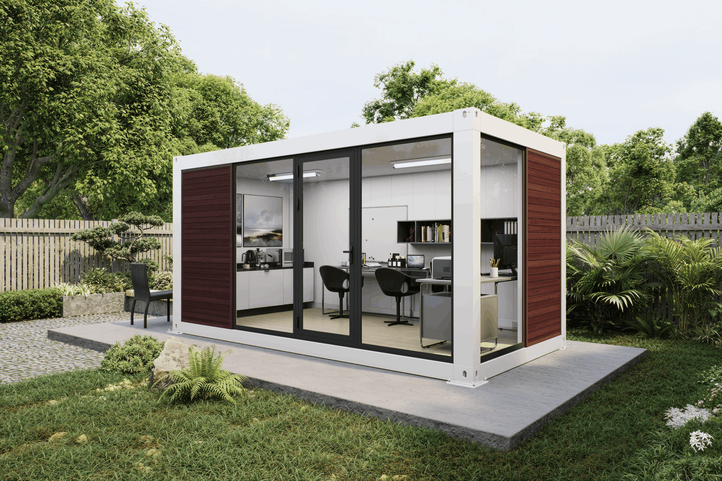 A modern modular office pod with a white container-style frame, dark wood side panels, and large black-framed glass doors, shown installed outdoors on a concrete pad in a landscaped garden with trees and shrubs.