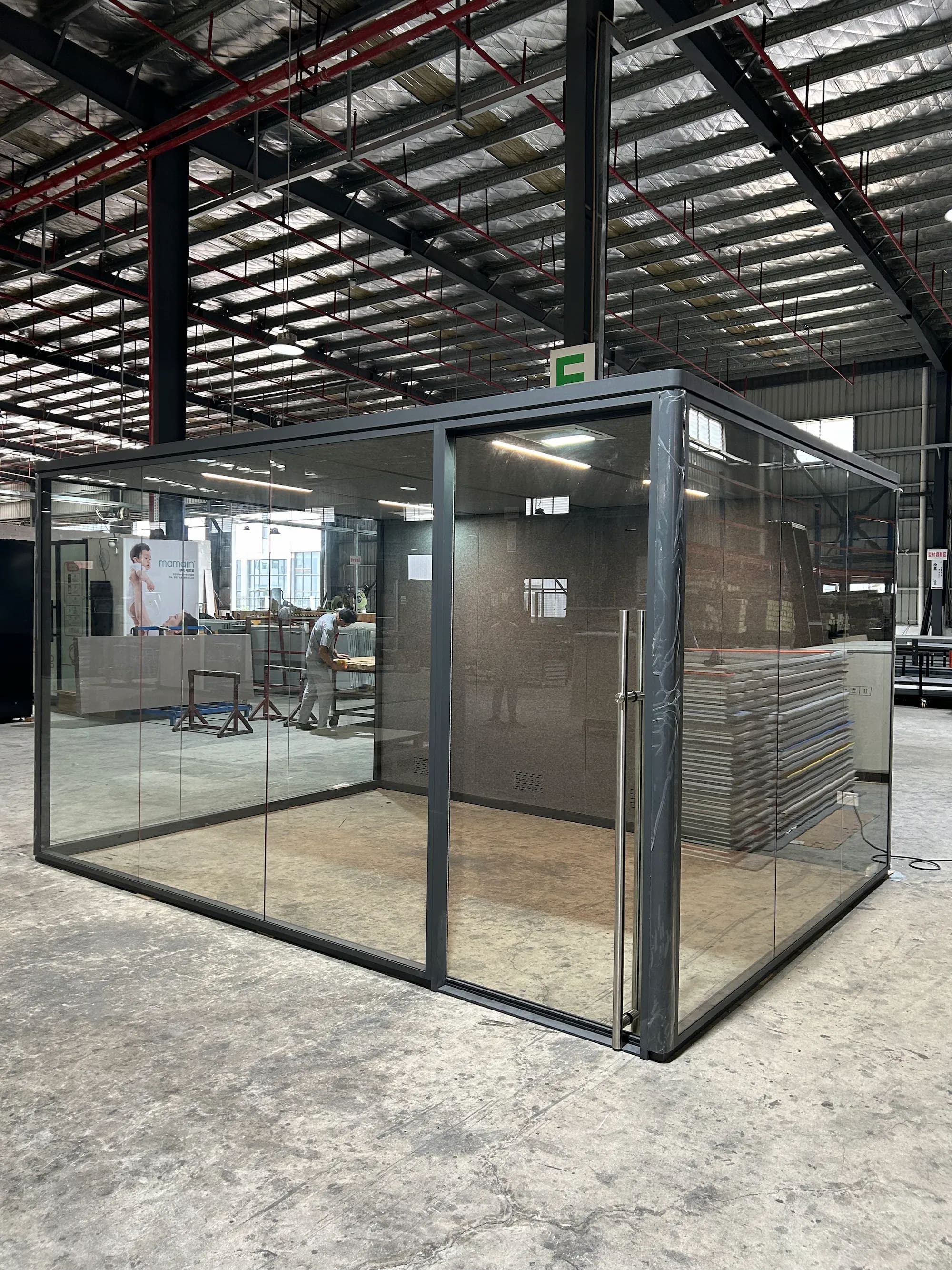 Glass office cube in an open plan building interior