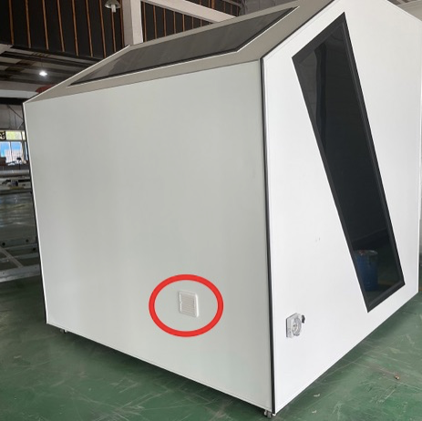 White industrial unit with a red circle around external fan on a concrete floor.