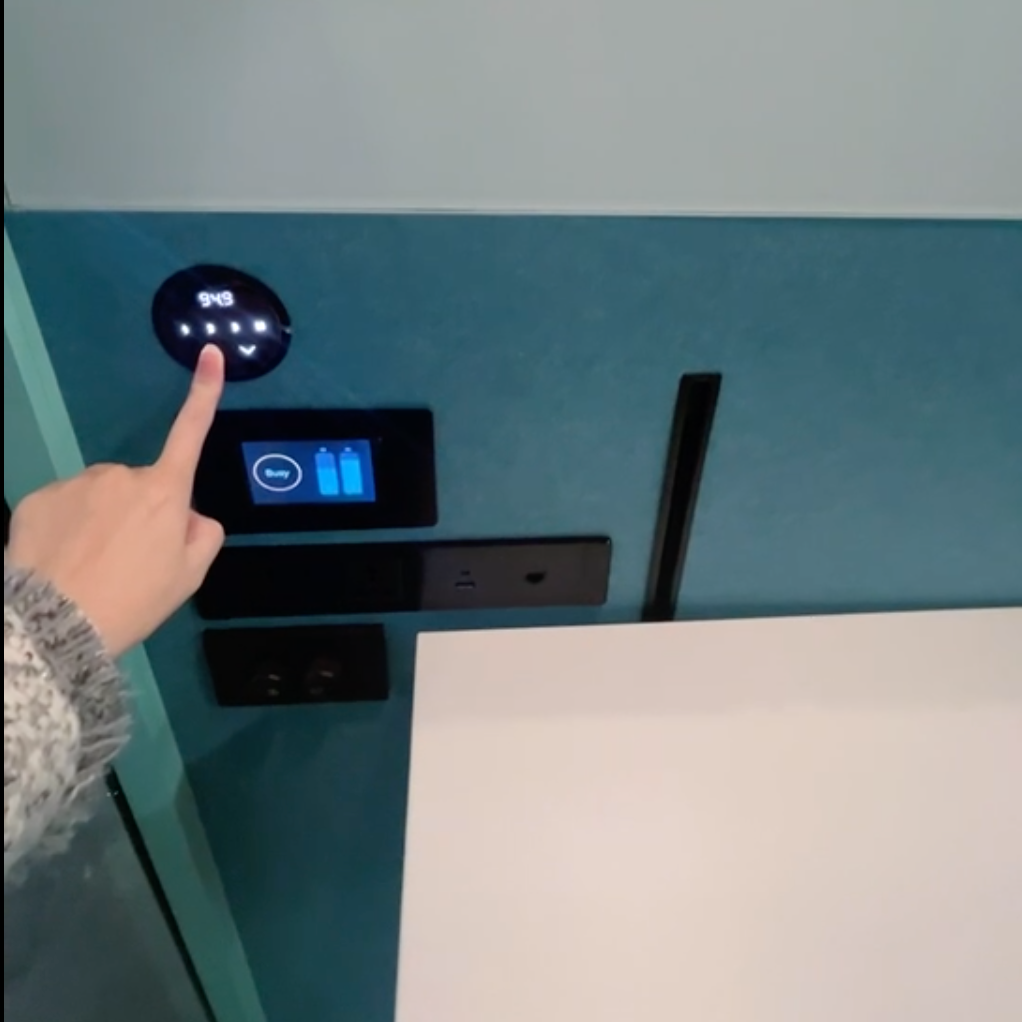 Digital controls for lifting desk with a hand pressing the button