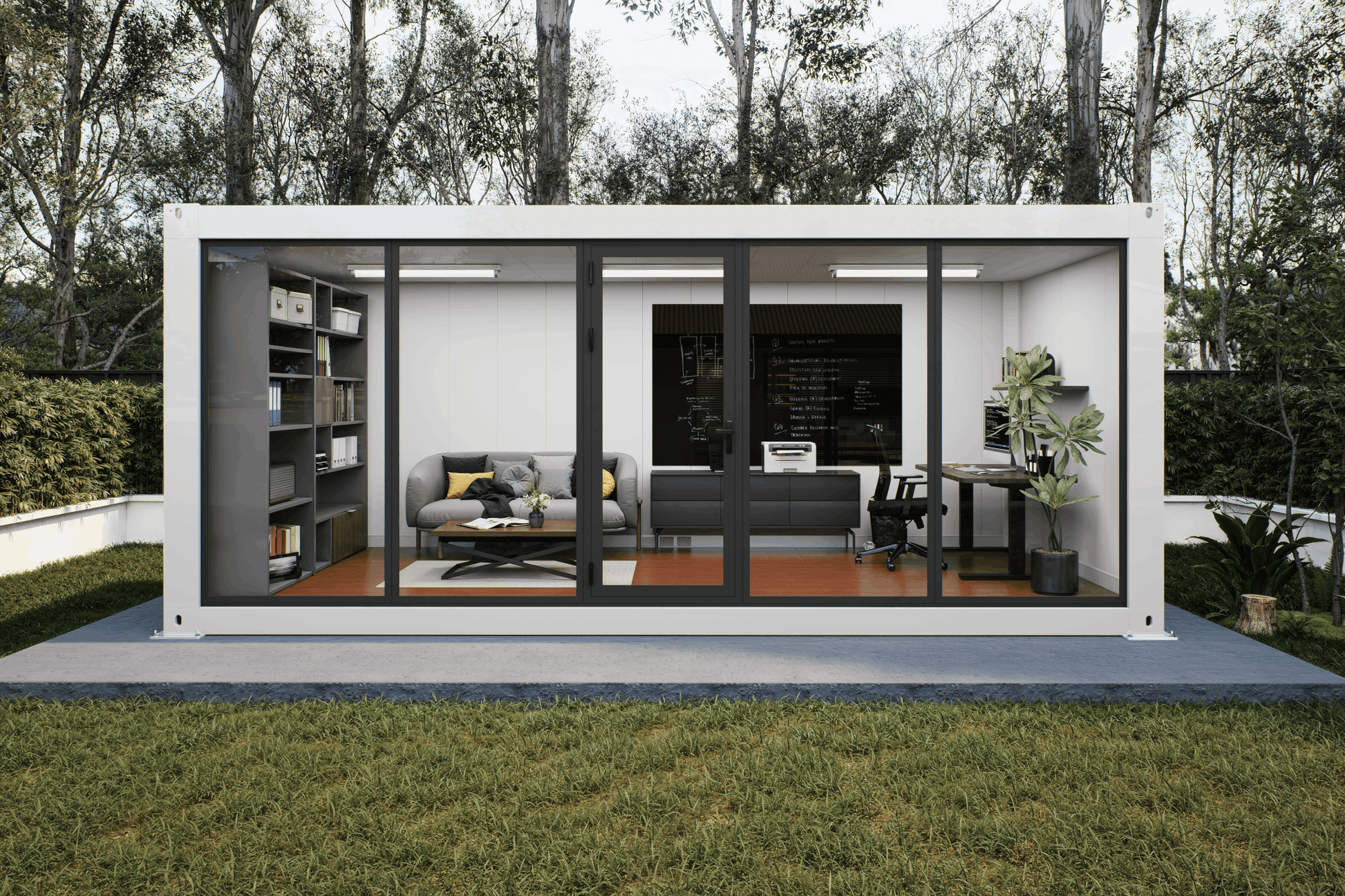 A modern white modular office or container home with large black-framed glass doors, shown open with furnished interior rooms including a gray sofa, desk, shelving, and office setup. The structure sits on a concrete pad in a grassy yard with trees behind it.