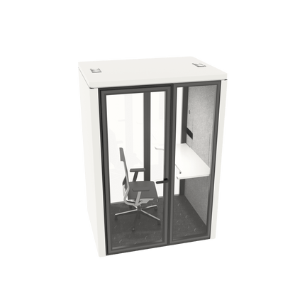 A modern office privacy booth with a white exterior, dark gray frame, and glass doors, featuring an interior desk, chair, and gray acoustic wall.