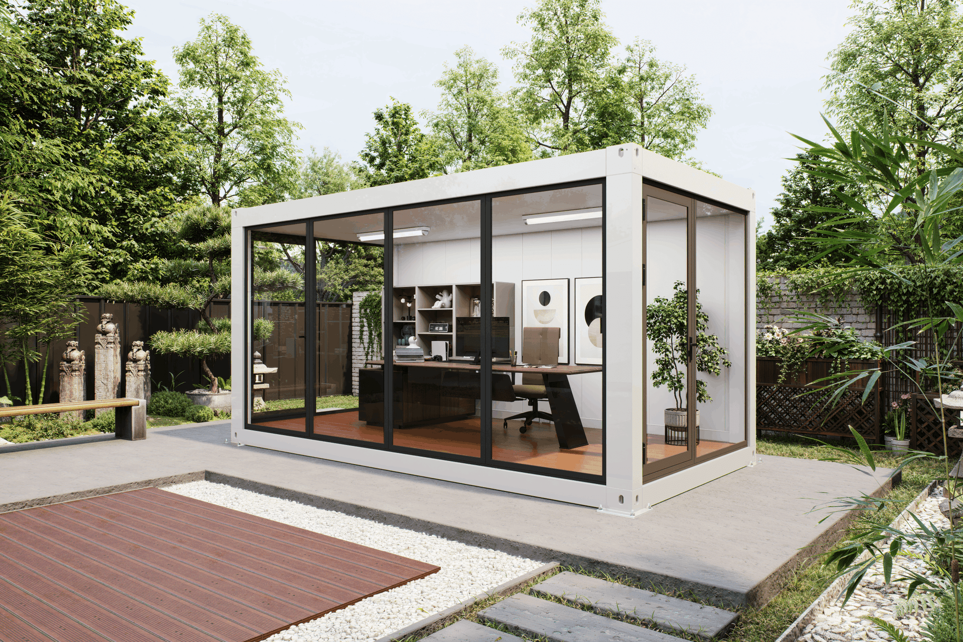 A modern white shipping container office pod with large black-framed glass windows, situated on a concrete patio in a lush green backyard setting.