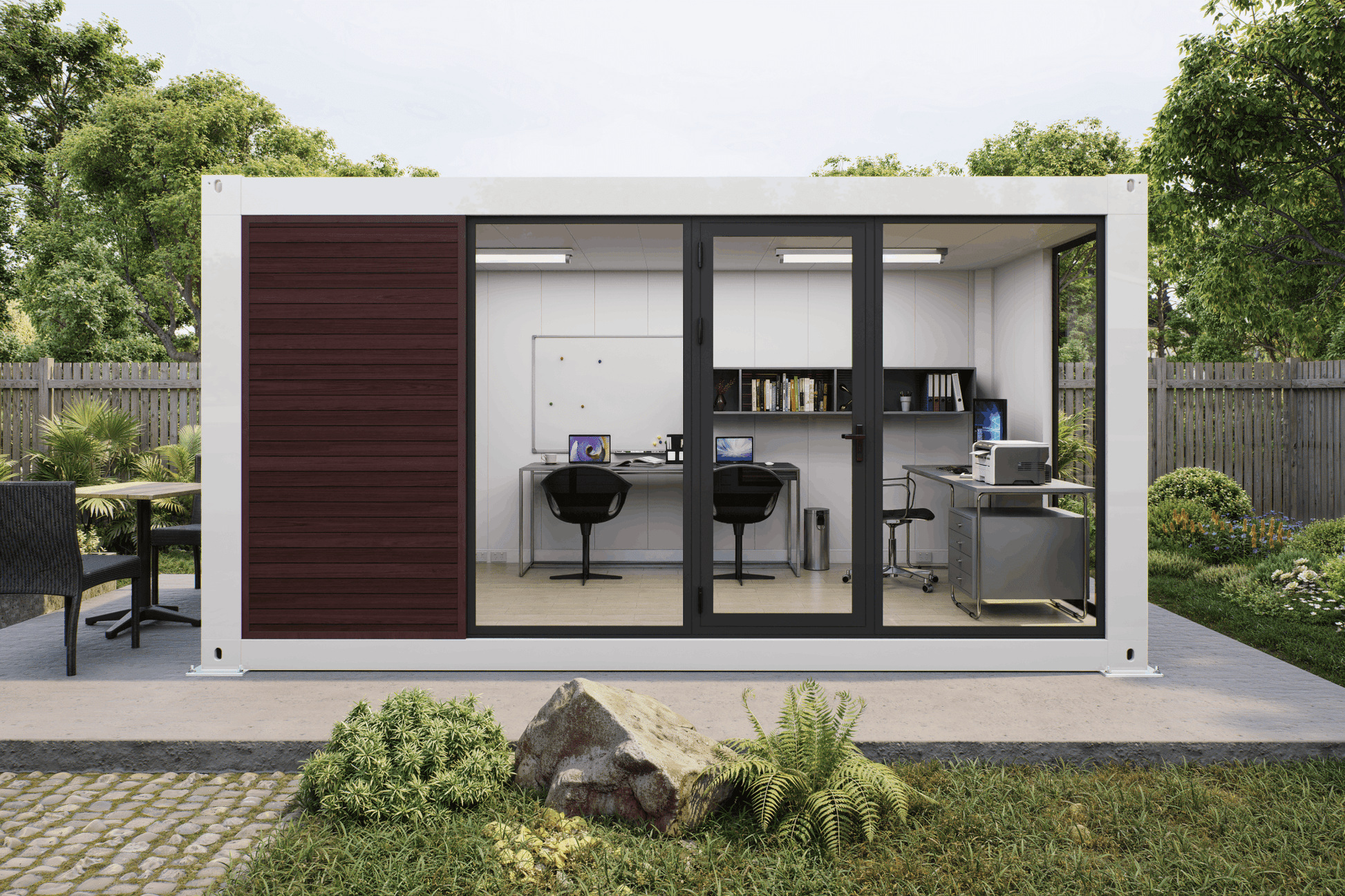 A modern modular office pod with a white exterior, dark brown wood paneling, and black-framed sliding glass doors, shown in a landscaped backyard setting with a furnished office interior visible inside.
