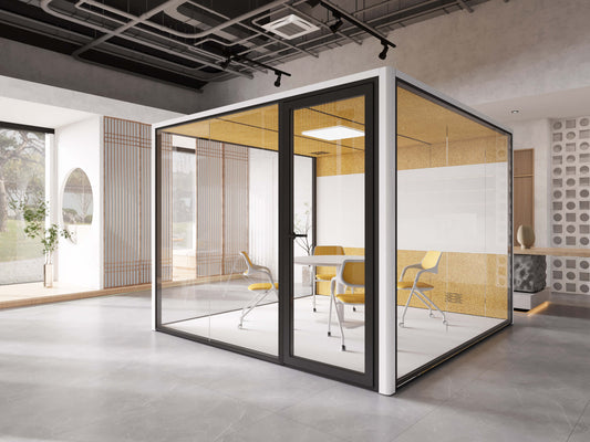 glass walled free standing modern meeting room in open plan office